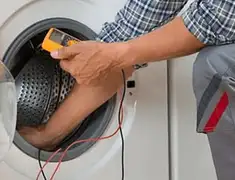 Washing machine repair technician testing a front-load washer with diagnostic tools in Springfield, MO